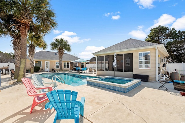 view of swimming pool with an in ground hot tub, a patio, and a sunroom