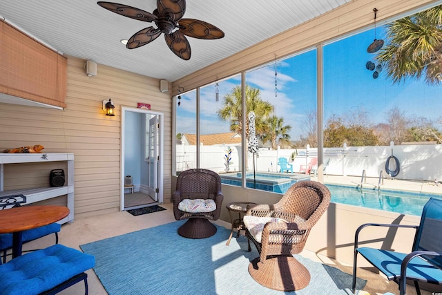 sunroom featuring ceiling fan