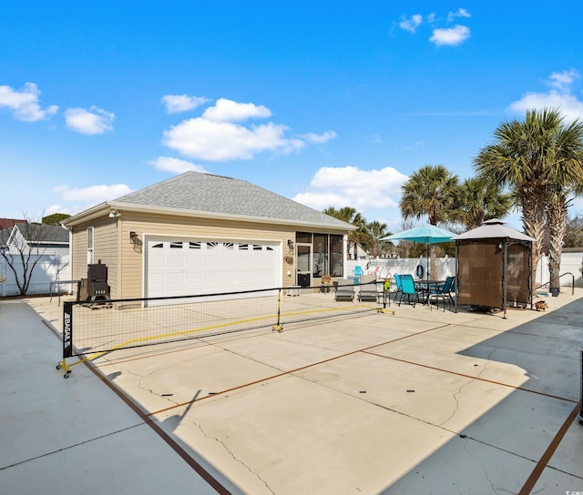 view of front of home with a garage and a sunroom