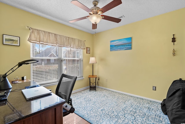 office area featuring ceiling fan and a textured ceiling