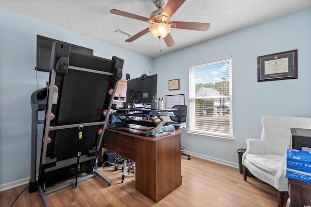 home office featuring ceiling fan, a textured ceiling, and light hardwood / wood-style flooring