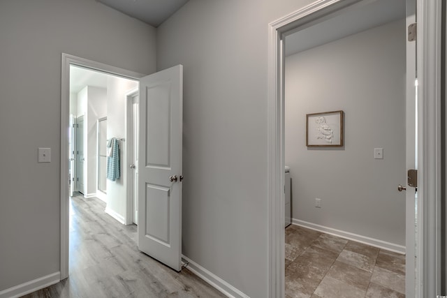 hallway featuring baseboards