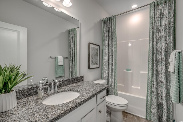 full bathroom with vanity, toilet, tile patterned flooring, and shower / tub combo