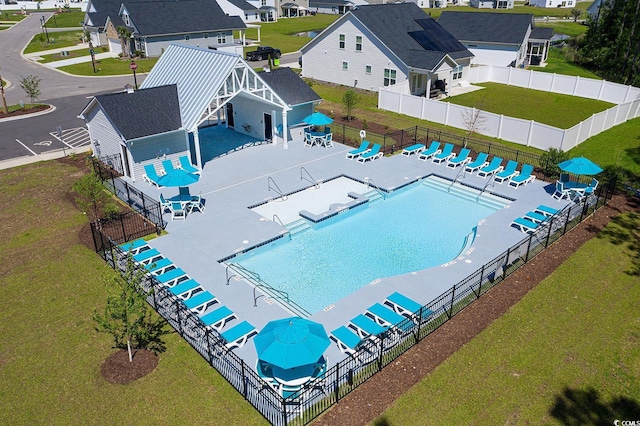 pool featuring a residential view and fence