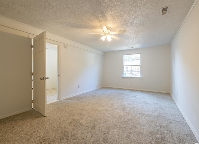 carpeted spare room featuring a textured ceiling and ceiling fan