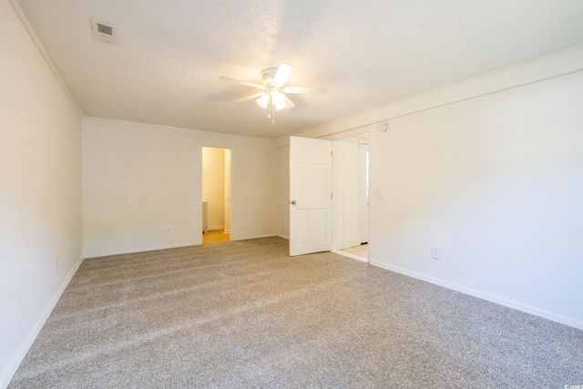 spare room with light carpet and a textured ceiling