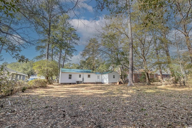 rear view of house featuring cooling unit