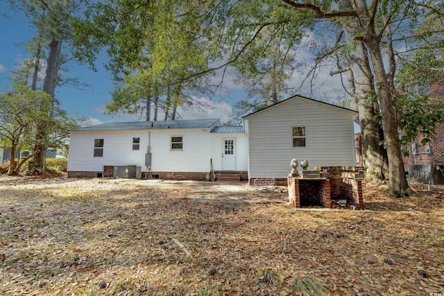 back of house with central AC unit