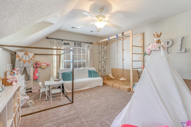 bedroom featuring ceiling fan, lofted ceiling, carpet, and a textured ceiling