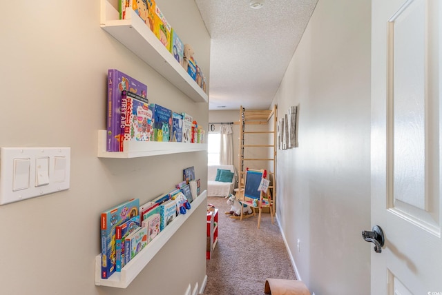 game room featuring a textured ceiling and carpet flooring