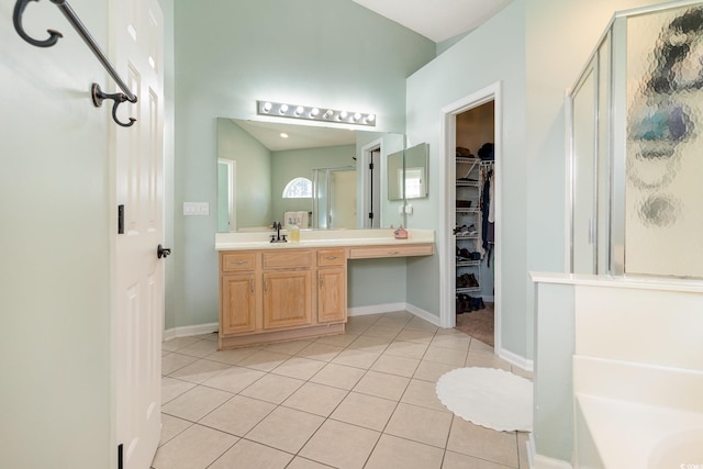 bathroom with tile patterned flooring, shower with separate bathtub, and vanity