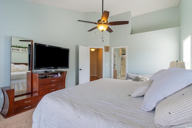 carpeted bedroom featuring ceiling fan and high vaulted ceiling