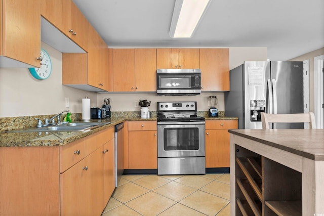 kitchen featuring light tile patterned flooring, appliances with stainless steel finishes, and sink