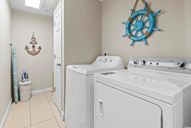 washroom featuring light tile patterned floors and washer and dryer