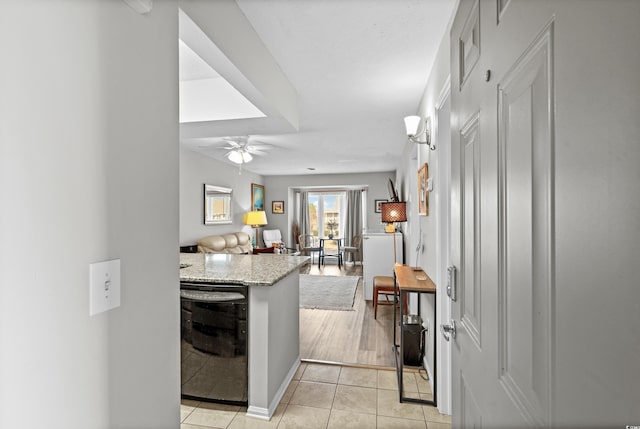 kitchen with ceiling fan, light stone countertops, dishwasher, and light tile patterned flooring