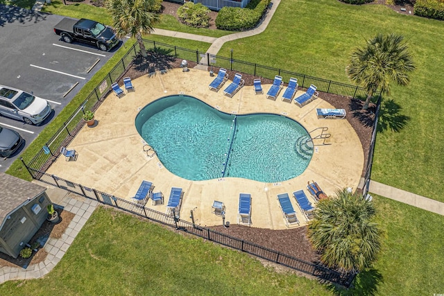 view of swimming pool with a yard and a patio area