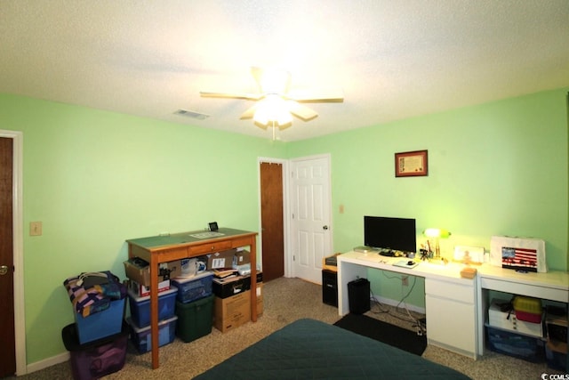 office area with ceiling fan, carpet floors, and a textured ceiling