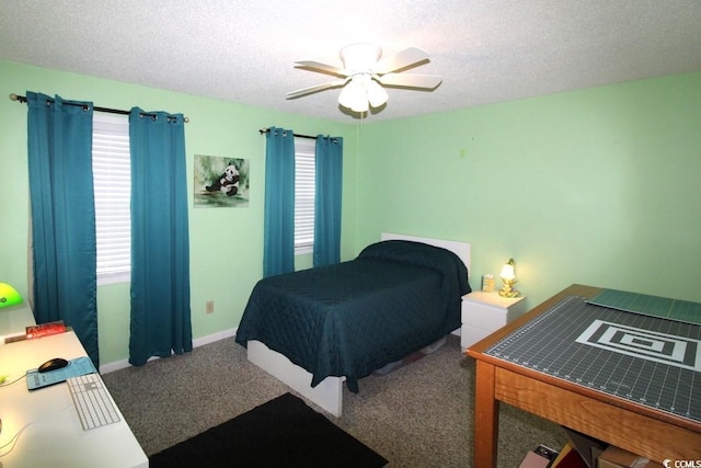 carpeted bedroom featuring ceiling fan and a textured ceiling