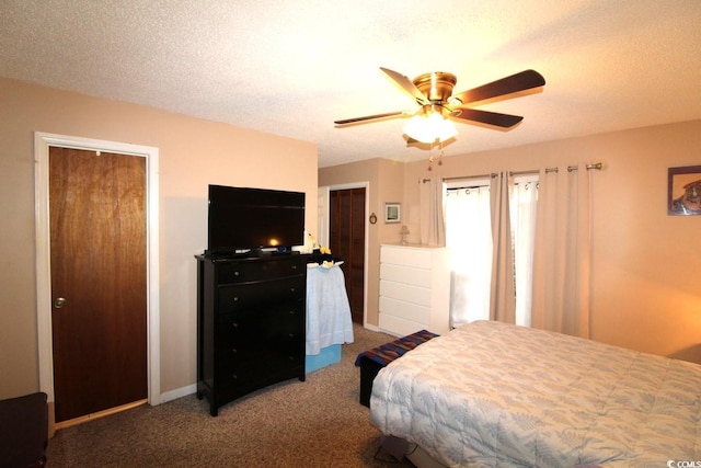 carpeted bedroom with ceiling fan and a textured ceiling