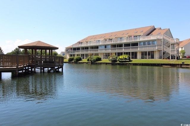 view of dock featuring a gazebo and a water view