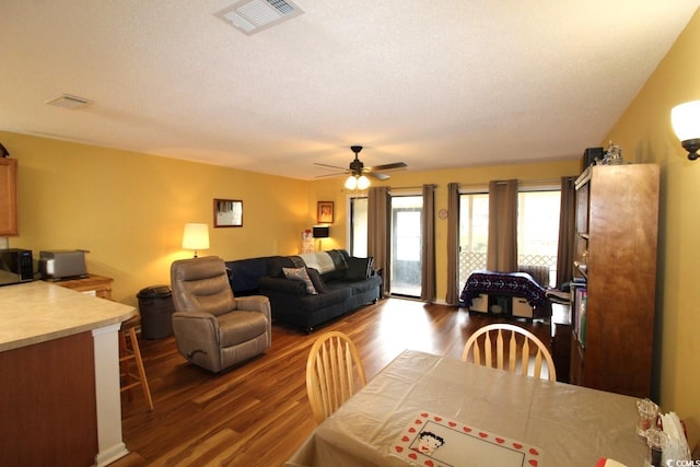 dining space featuring hardwood / wood-style flooring, ceiling fan, and a textured ceiling