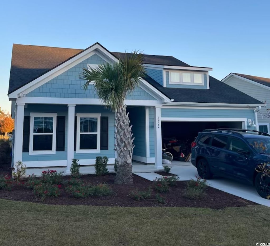 view of front of property featuring a garage and a front lawn