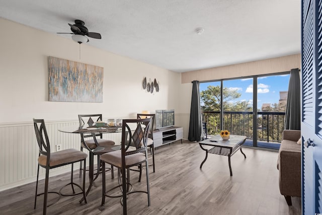 dining room with hardwood / wood-style flooring and a textured ceiling