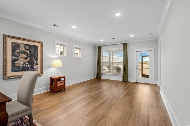 office with light hardwood / wood-style flooring and ornamental molding