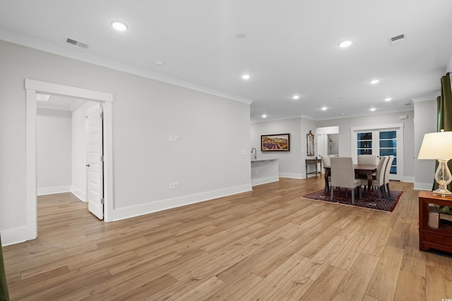 6614 Torino Ln, Myrtle Beach, SC 29572 - living room with crown molding, light wood-style flooring, recessed lighting, baseboards, and bar with sink