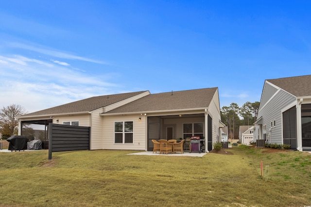 rear view of house featuring a patio area, central air condition unit, and a lawn