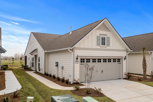 6614 Torino Ln, Myrtle Beach, SC 29572 - view of side of home featuring board and batten siding, roof with shingles, driveway, a yard, and central AC