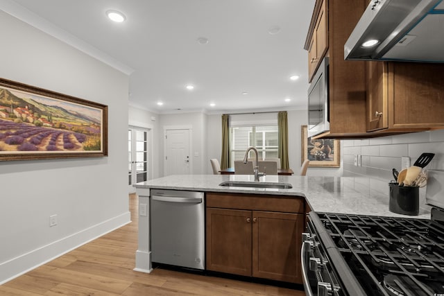 6614 Torino Ln, Myrtle Beach, SC 29572 - kitchen featuring stainless steel dishwasher, exhaust hood, a sink, a peninsula, and crown molding