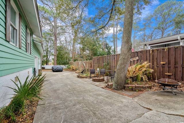 view of patio / terrace featuring fence and a fire pit