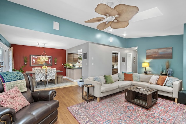 living room with ceiling fan and wood finished floors