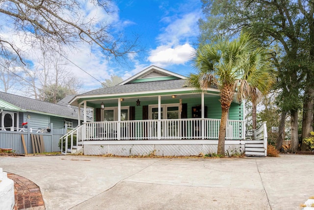 view of front facade with a porch and fence