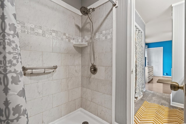 bathroom featuring a stall shower and wood finished floors