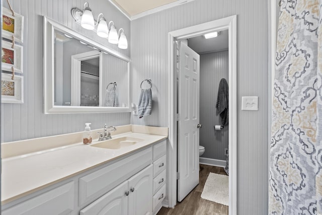 full bathroom featuring vanity, toilet, and wood finished floors