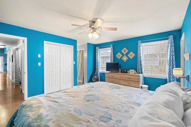 bedroom featuring baseboards, a ceiling fan, and wood finished floors