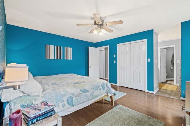 bedroom featuring ceiling fan, a closet, wood finished floors, and baseboards