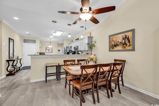 dining area featuring ornamental molding, ceiling fan, and light hardwood / wood-style floors