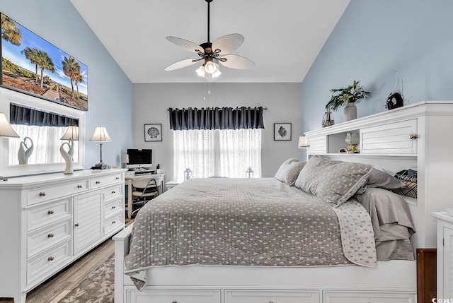 bedroom with hardwood / wood-style floors, vaulted ceiling, and ceiling fan