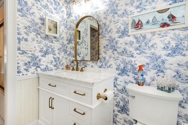 bathroom featuring vanity and toilet