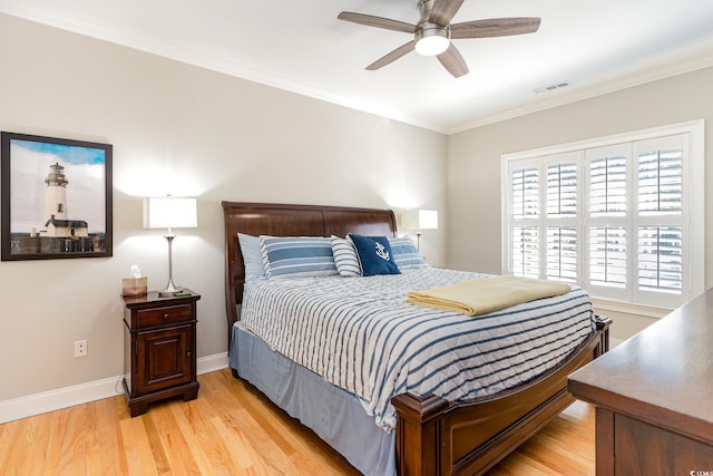 bedroom featuring crown molding, ceiling fan, and light wood-type flooring