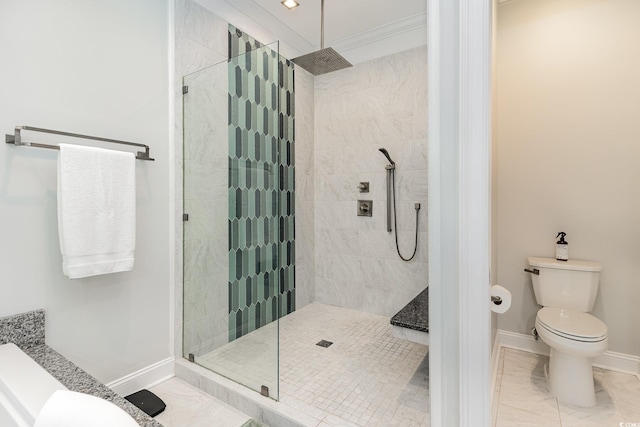 bathroom with ornamental molding, toilet, and tiled shower