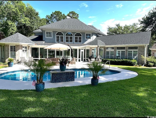 back of property featuring a yard and a patio