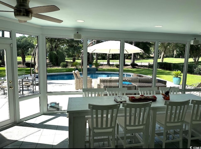 sunroom featuring ceiling fan