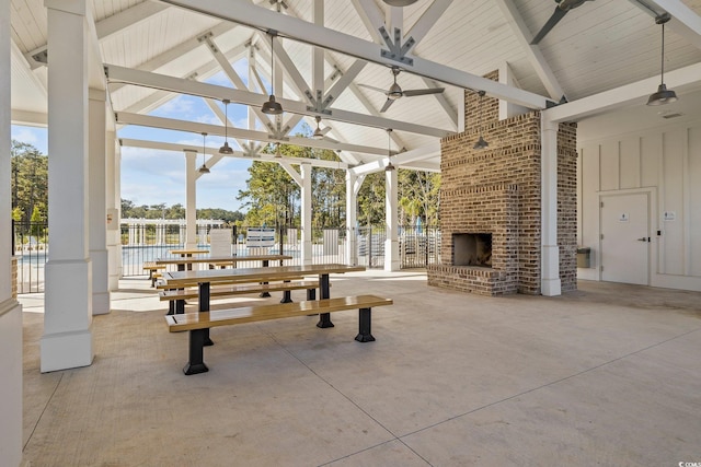 view of home's community featuring an outdoor brick fireplace, ceiling fan, and a patio