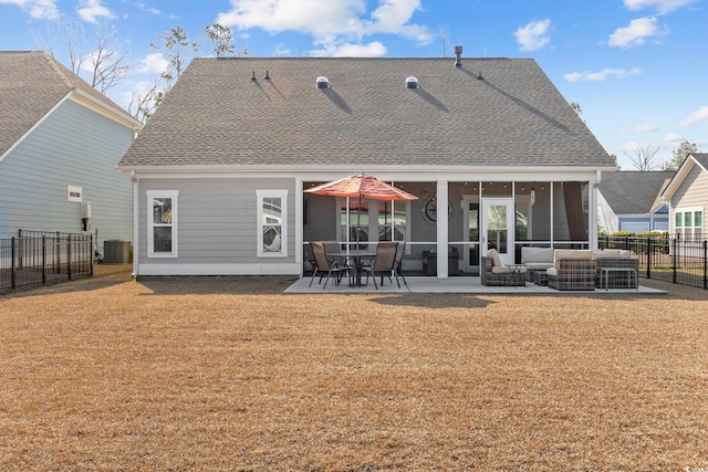 back of house featuring a yard, a patio, central AC unit, a sunroom, and an outdoor hangout area