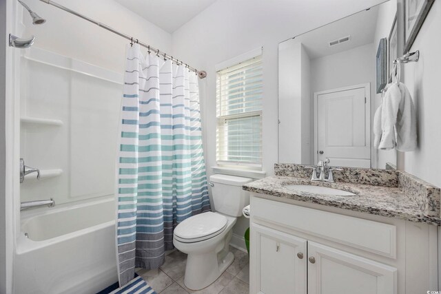 full bathroom with vanity, tile patterned floors, shower / bath combination with curtain, and toilet