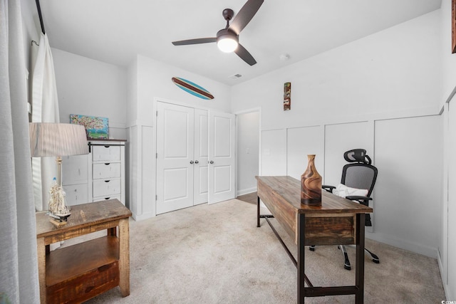 carpeted office featuring ceiling fan